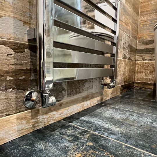 Close-up off chrome radiator in bathroom