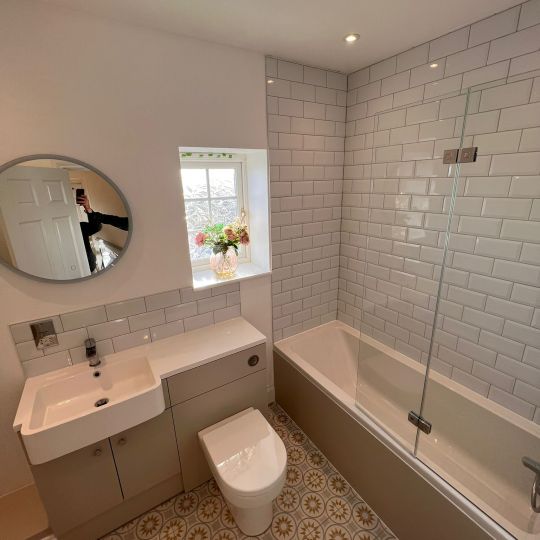 Bath with over-bath shower. Piha Plumbing and Bathroom Installations