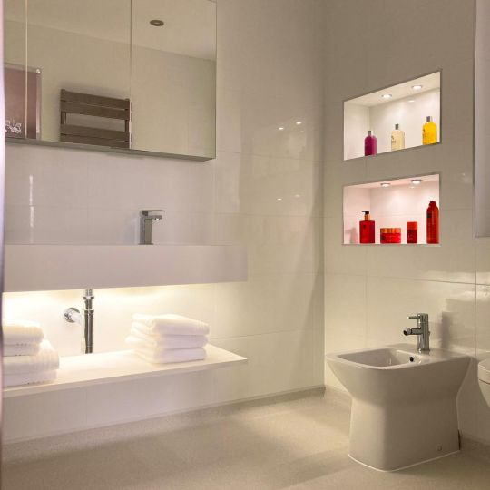 Recessed bathroom shelves with integrated lighting