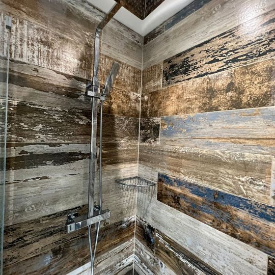 Square shower rose in Chrome. Bathroom designed and installed by Piha Plumbing and Bathroom Installations